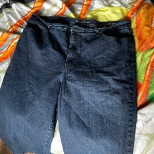 Dark blue jeans with pockets. Back pockets have some embellishments.